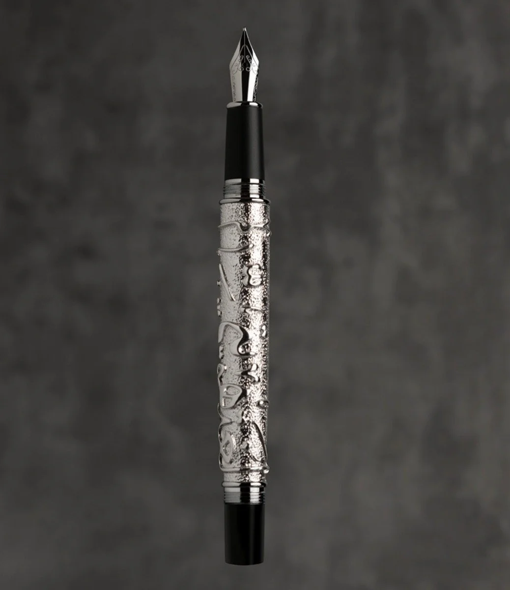 The engraved Dhad fountain pen with Thuluth calligraphy on the body of the pen stating "My language is my Identity"