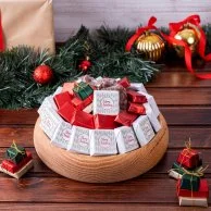 Christmas Choclate arrangement in a Round Wooden Plate by Lilac 