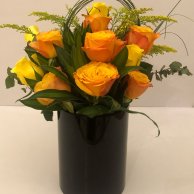 Yellow roses in a black vase arrangement